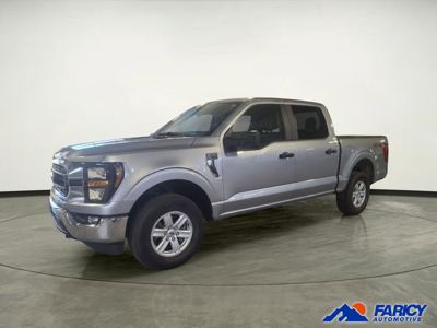 Silver Ford F-150 pickup in a dealer showroom