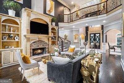 Two-story living room with a stone fireplace